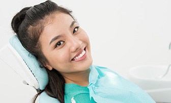 Smiling woman sitting back in dental chair