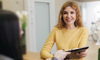 Patient smiling after learning the cost of a dental crown in Greensboro