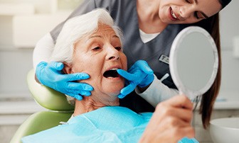 Dentist showing a patient what the problem might be