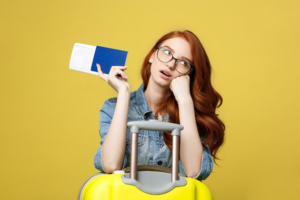 Woman on yellow background holding passport and looking stressed